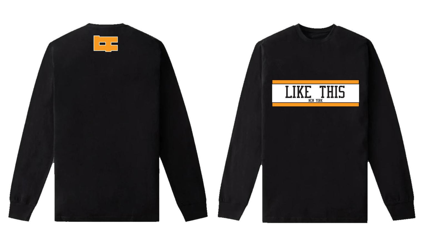 Black Long sleeve Shirt made with 100% Cotton with Like This written in black on a white background across the chest horizontally between two orange lines. On the back right under the Collar there is an orange LT logo.